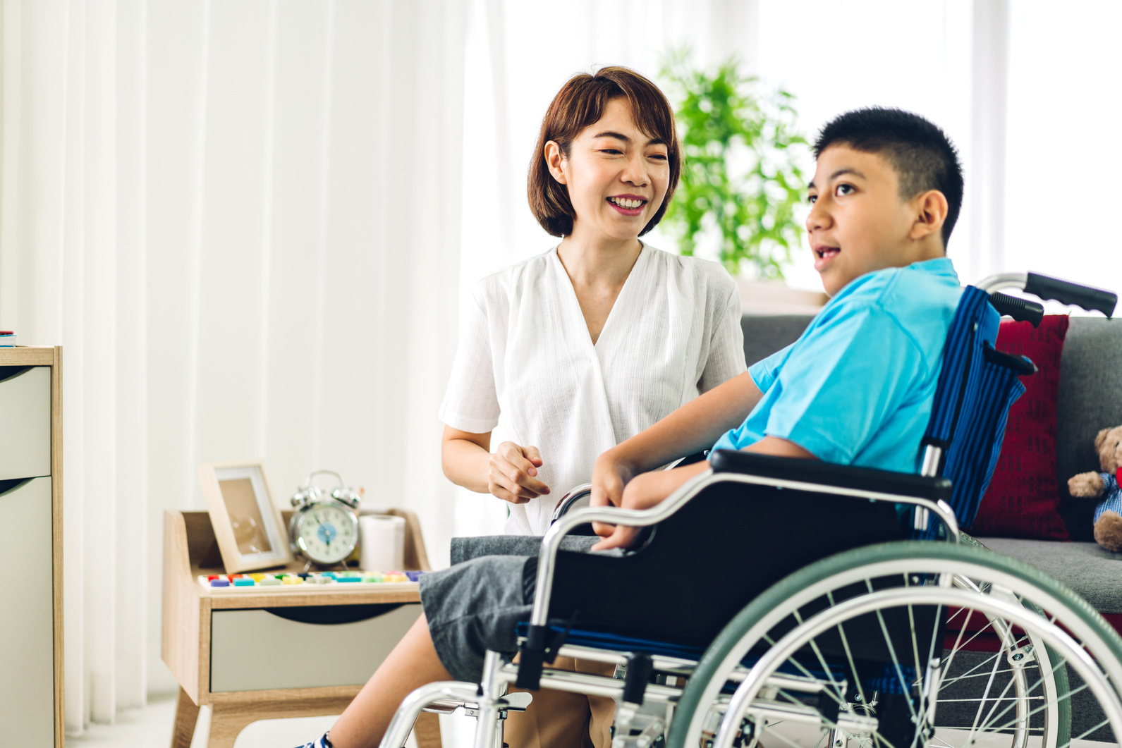 Portrait of Asian Physiotherapist Carer Helping and Playing with